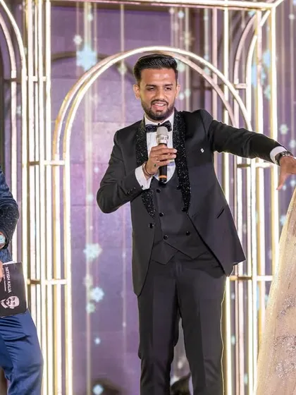 Sharing a laugh with the groom and bride on their Sangeet stage in Lonavala. My approach is all about creating genuine, unscripted moments of joy.