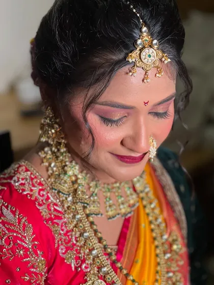 A close-up of my bride Pooja, featuring a bold red lip and dramatic eye makeup for a royal Maharashtrian look.