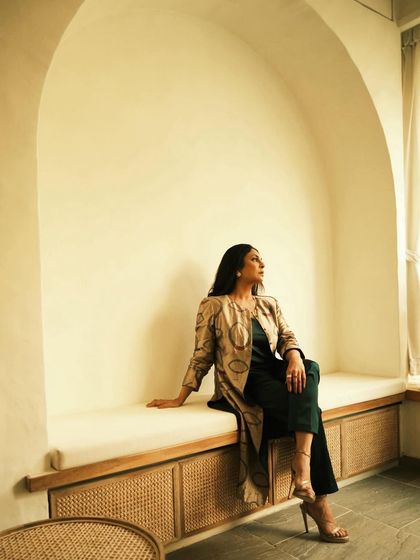 This wide shot places Shefali in a beautiful architectural nook, adding to the artistic and serene mood of the photo.