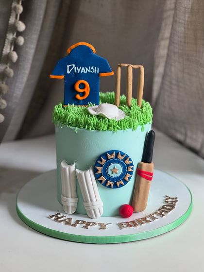 Bringing the stadium to the party! This cricket-themed cake features all the essentials: a personalized jersey, stumps, pads, and a bat and ball, all handcrafted from fondant.