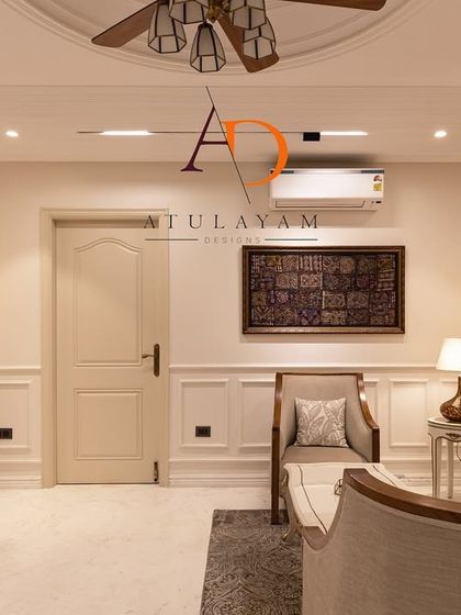 A detail shot of the wall moulding and modern art deco wall sconces, highlighting the fusion of classic and contemporary elements.