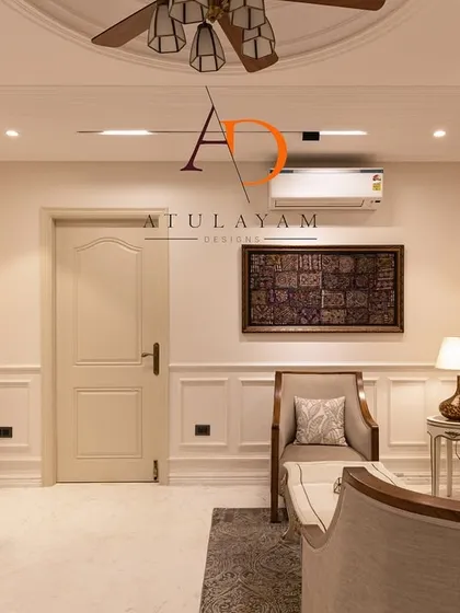 This angle shows the classic wall mouldings and warm lighting that contribute to the room's timeless and sophisticated atmosphere.
