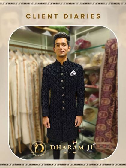 A client in a classic black velvet sherwani with intricate embroidery. He looks elegant and ready for a formal wedding event.