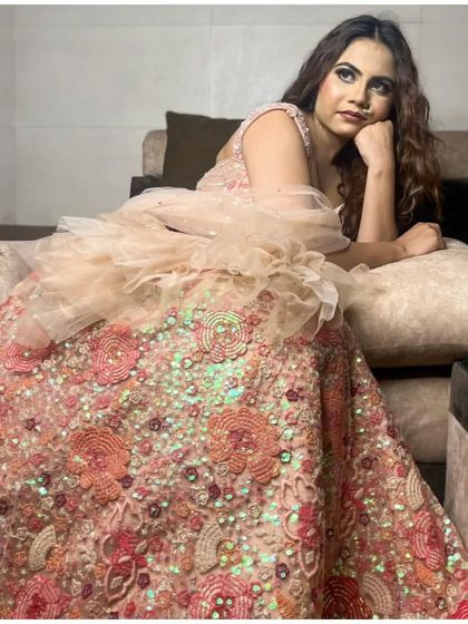 The full flare of this peach floral lehenga is simply breathtaking. Rent this for your next event.