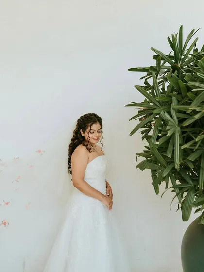 A beautiful, artistic shot against a white wall. The simplicity of the background makes her and her dress the true focus.
