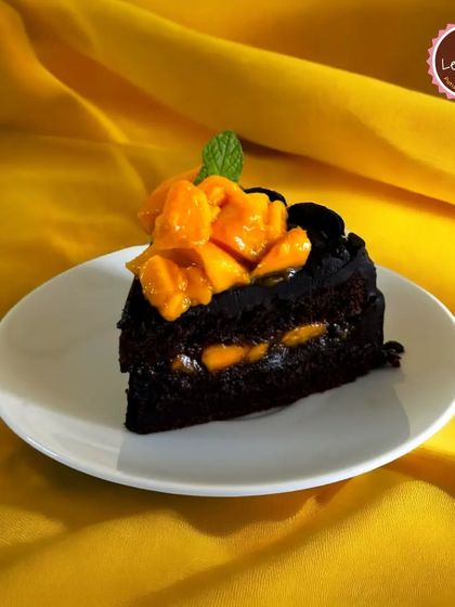 A unique combination of rich chocolate and sweet mango. This slice of chocolate cake has a fresh mango filling, offering a surprising and delicious tropical twist on a classic.