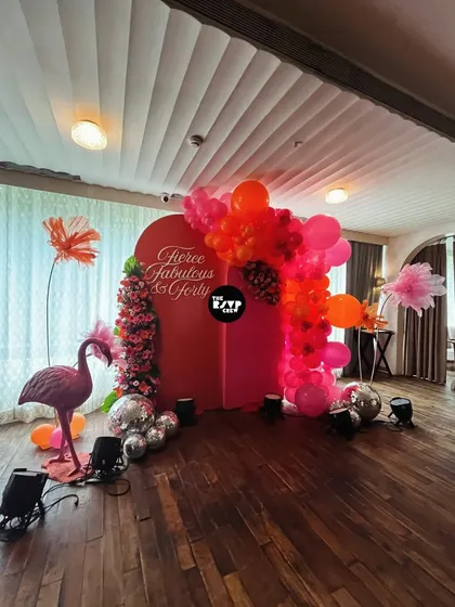 Who says kids get to have all the fun? This 'Fierce, Fabulous & Forty' milestone birthday was all about chic vibes, featuring a bold red backdrop, a tropical flamingo, and a cascade of pink and orange balloons with disco balls.