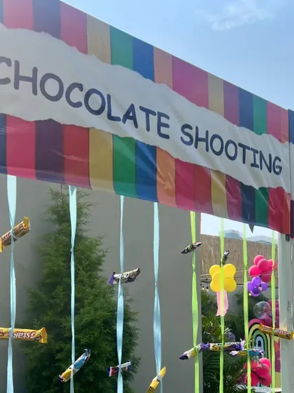 A "Chocolate Shooting" game stall is a sweet and fun challenge for party guests.