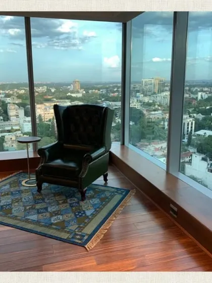 A perfect reading corner with a view. We placed this classic wingback chair by the window to create a comfortable spot to relax and enjoy the cityscape.