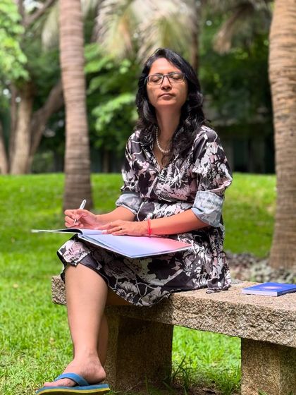 A photo of me writing on a park bench. When you write with truth and pure intention, you are not just a person writing; you are a vessel for something divine flowing through you.