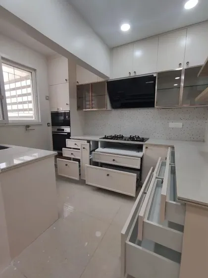 A duplicate of 68, showing the kitchen with all its drawers open to demonstrate the extensive and well-planned storage capacity.