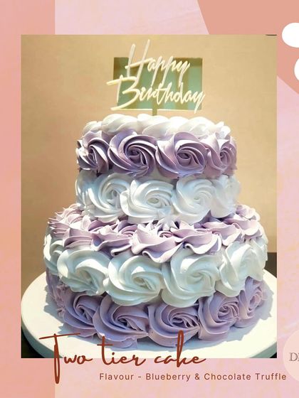This popular two-tier rosette cake in shades of purple and white is a versatile choice for birthdays, baby showers, or weddings. The full-coverage piping creates a lush, floral effect.