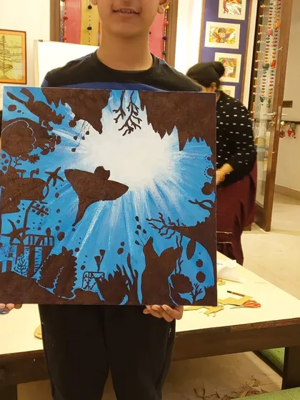 A burst of light as seen from underwater. This striking silhouette painting on canvas was created by a student in my 8 to 12-year-old class.