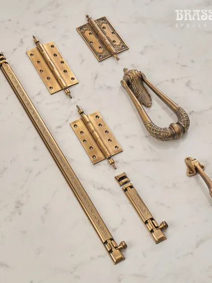 A full suite of hardware from the Mumtaz Collection, including a door knocker, tower bolt, and intricately engraved hinges. This demonstrates our ability to provide a complete, heritage-inspired hardware story.