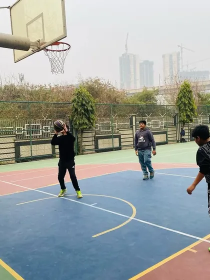 A player practices his shot, with the basket in clear view.