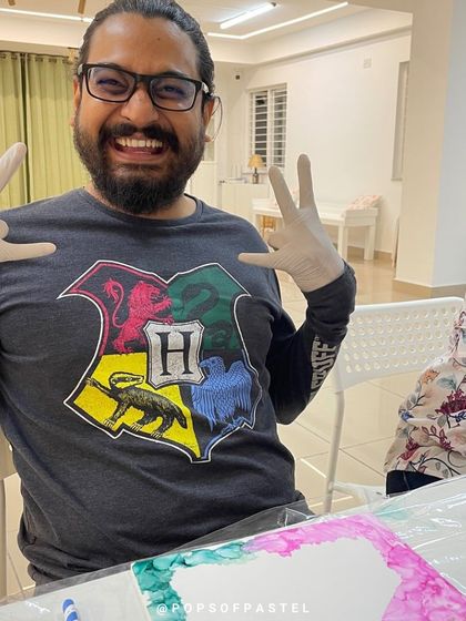 The excitement is real. This participant is having a great time experimenting with alcohol inks.