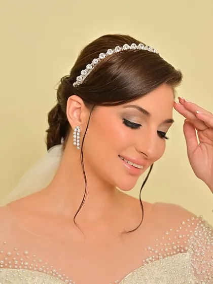 A close-up of the soft eye makeup and the elegant hairstyle, perfect for a classic church wedding.