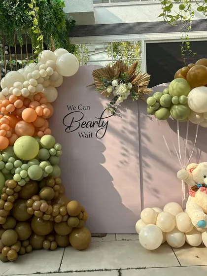 The full view of our earthy 'We Can Bearly Wait' backdrop, featuring a stunning organic balloon arch and a floating teddy bear. This setup is perfect for an elegant, gender-neutral baby shower.