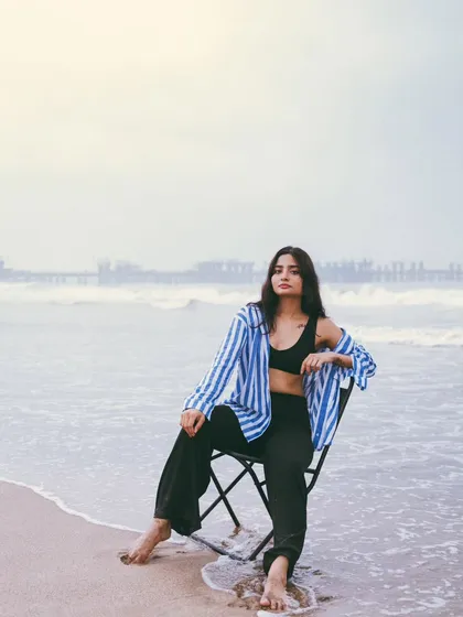 Another seated pose, this time with the city skyline faintly visible in the background, blending the urban and natural elements.