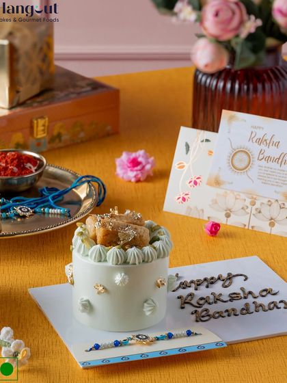 This Milk Malai Micro Cake is the "shagun ka meetha" of our Rakhi collection. It combines vanilla sponge with nutty dry fruits and flavored whipped cream, and comes with a greeting and an evil eye rakhi.