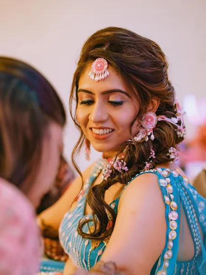 For this Mehendi look, I created a voluminous side braid and decorated it with beautiful floral jewelry. The style is both practical for the ceremony and incredibly photogenic.