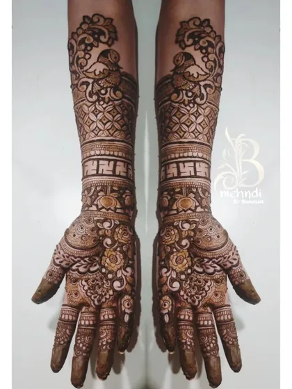 I believe mehndi is the most beautiful jewelry. This design shows my love for detailed traditional work, featuring symmetrical peacocks, fine jaali net patterns, and auspicious swastika symbols for a classic bridal style.