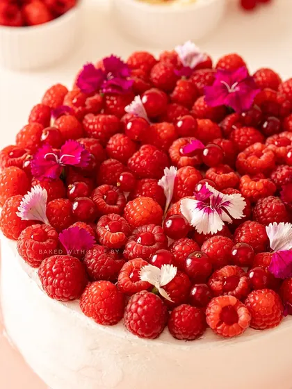 The berry cake of your dreams. My vanilla sponge is soaked in a three-milk concoction and layered with Belgian white chocolate mousse, raspberry compote, and fresh raspberries.