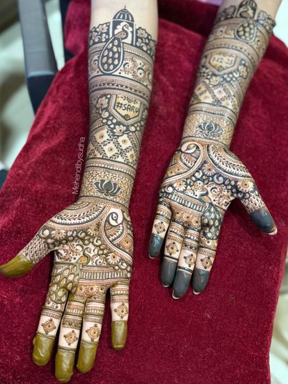 A beautiful engagement mehendi with peacocks, lotuses, and the couple's hashtag, a modern twist on a traditional design.