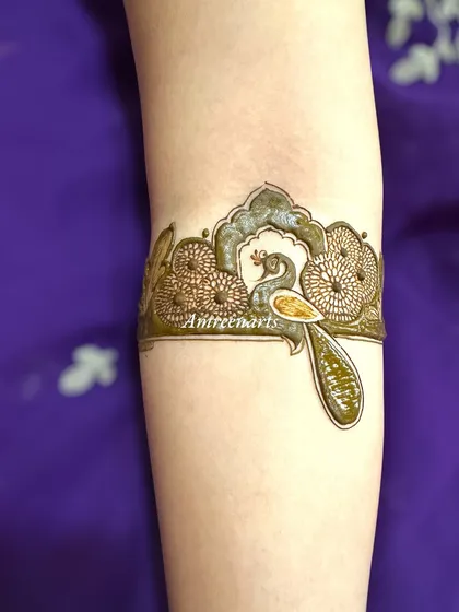 A delicate peacock arm band, perfect as a standalone piece or part of a larger design.