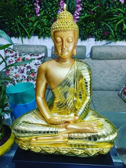 For a touch of luxury, I offer this stunning golden Buddha statue. It's an eye-catching decor piece that brings warmth and tranquility.