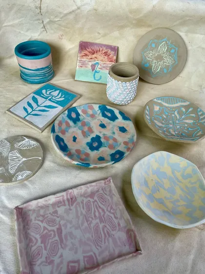 Another angle of the vibrant, finished student pieces. This image highlights the diverse styles, from floral patterns and marbled effects to intricate mandala designs.