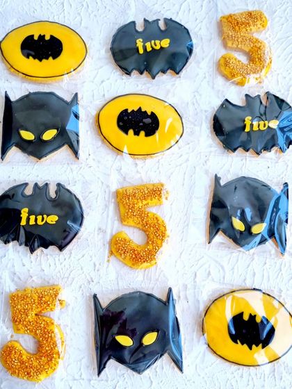 A collection of Batman-themed sugar cookies. I teach how to flood cookies with royal icing and add details to match any party theme.