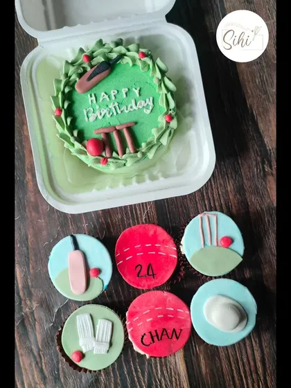 A perfect set for a cricket fan's birthday. The bento cake features a mini cricket pitch, while the matching cupcakes are decorated with fondant bats, balls, wickets, and pads.