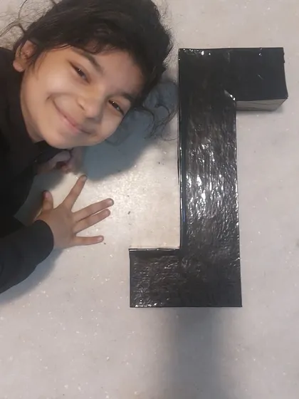 This happy student is posing with her completed periscope. My role is to help them turn school assignments into exciting learning opportunities.
