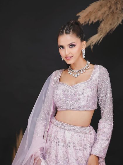 A three-quarter shot of the lavender lehenga, providing a clearer view of the skirt's design and the overall silhouette.