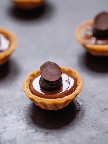 A double dark chocolate tartlet, a mini version of our classic dessert. These are perfect for when you want just a bite of something rich and decadent.