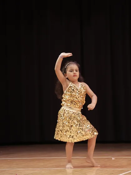 Every star has a beginning. This is one of our 'Little Champs' performers, capturing the joy and focus we nurture in our youngest dancers from their very first show.