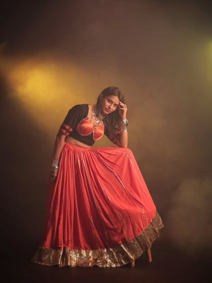 A more intimate and relaxed pose from our Navratri series. The soft, hazy light adds a touch of mystery and allure to this cultural portrait.