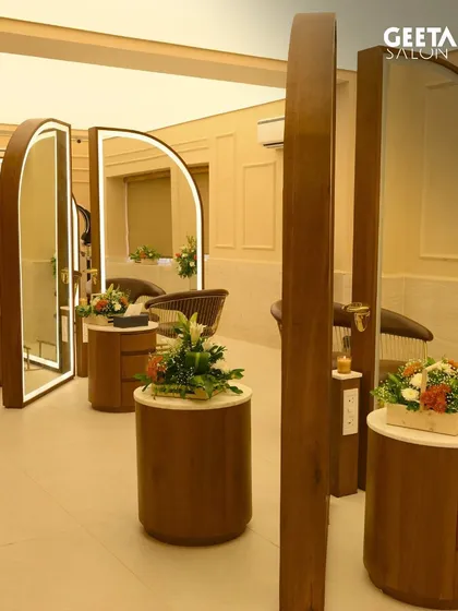 The beautifully designed cutting stations at our Bhubaneswar salon. The arched mirrors and warm wood create a sophisticated and comfortable space for your makeover.