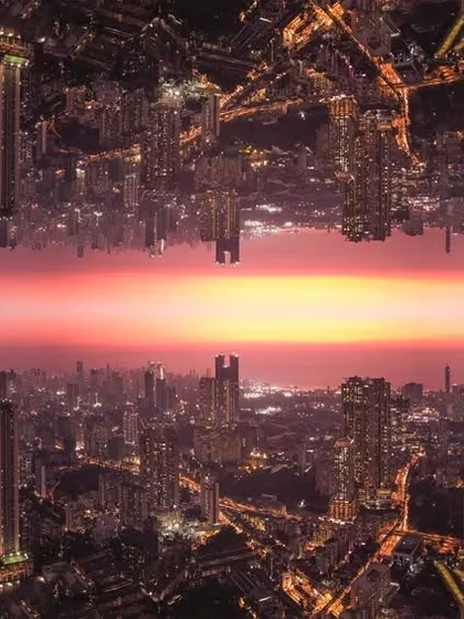A creative edit of Mumbai's nightscape, mirrored to create a surreal, matrix-like world with a sunset horizon in the middle.