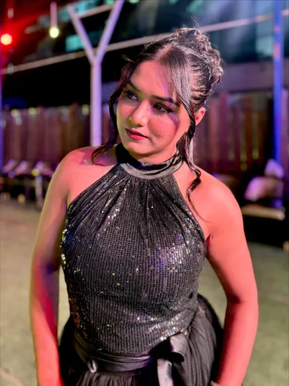 A close-up of the black gown, showing the texture of the sequined fabric and the elegant braided hairstyle I paired with it for a complete look.