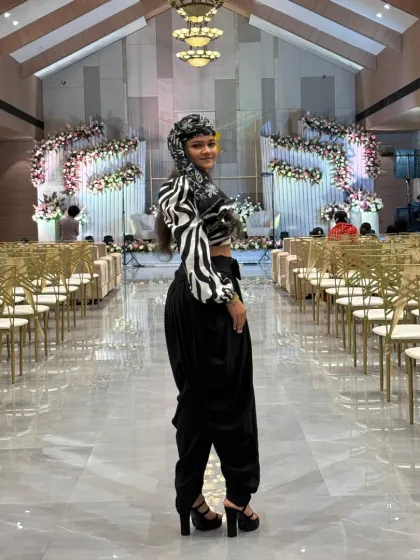 A full view of my modern-ethnic outfit for a wedding reception, standing in the grand, beautifully decorated hall before guests arrive.