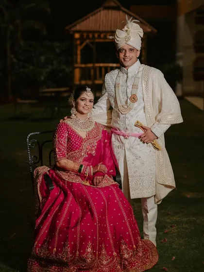 A beautiful portrait of my bride Deepika and her groom. Her pinkish-red lehenga is complemented by soft, glowing makeup that looks stunning in the evening light.