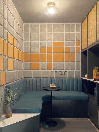 Inspired by a client's love for San Francisco, I transformed a small storeroom into an intimate coffee nook. The design uses textured wall panels and plush seating to create a cozy escape within the home.