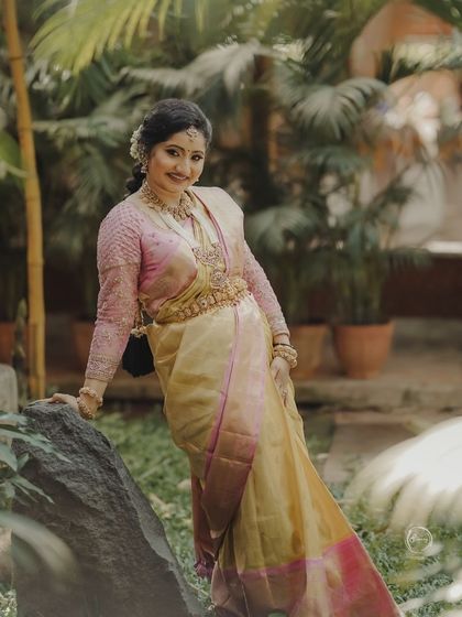 Our client Vaishnavi in a rich tissue pure-zari designer silk saree in beautiful yellow and pink pastels.