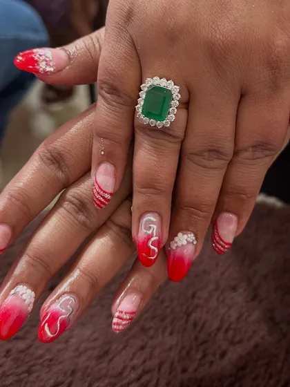 For the bride who loves a bit of drama. This custom set features red ombre tips with silver glitter stripes and initial "GS" nail art, making it super personal and unique.