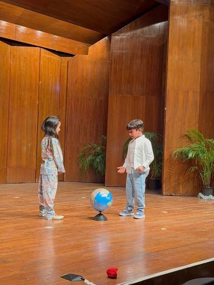 A scene exploring the world, where students use props like a globe to tell their story.