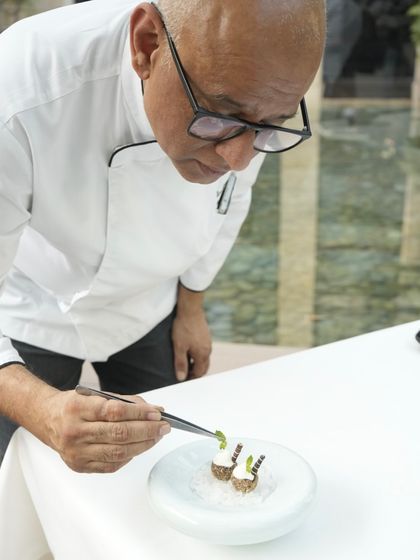 Chef Shantanu Mehrotra carefully places a garnish on a dessert. Each course in our tasting menu is a study in balance, crafted with a steady hand and a clear vision.