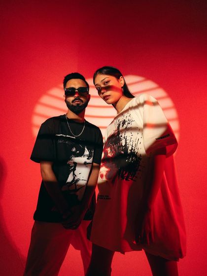 A confident duo shot for Varsey. The models' direct gaze and the bold red background create a powerful image that showcases the brand's unisex appeal.