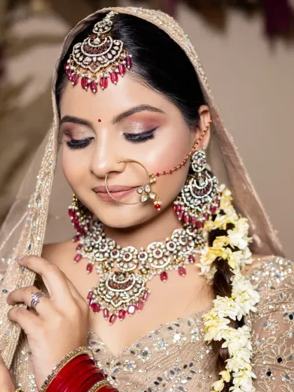 A traditional bridal look with a focus on warm tones and classic elements. This photo from a student's portfolio demonstrates their ability to cater to different bridal styles.